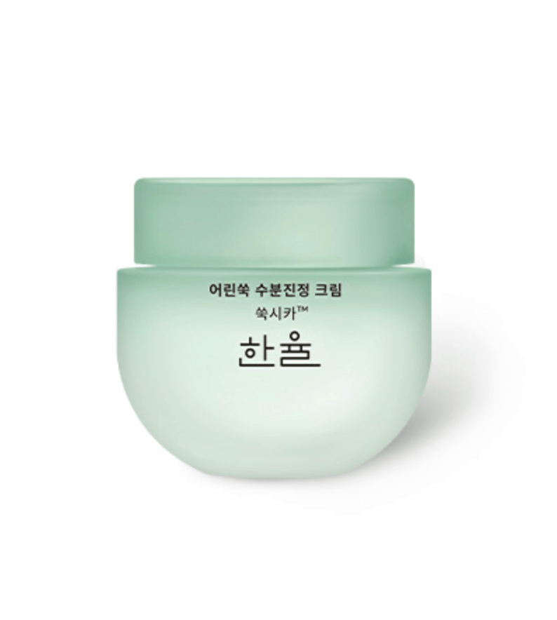 A light green jar of Hanyul Korean skincare cream labeled with text in Korean, featuring a modern and minimalist design.