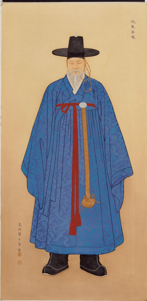 A traditional portrait of a man in a blue hanbok, featuring ornate patterns. He has a long beard and wears a black gat hat. A red ribbon is tied around his waist, and he holds a ceremonial object.